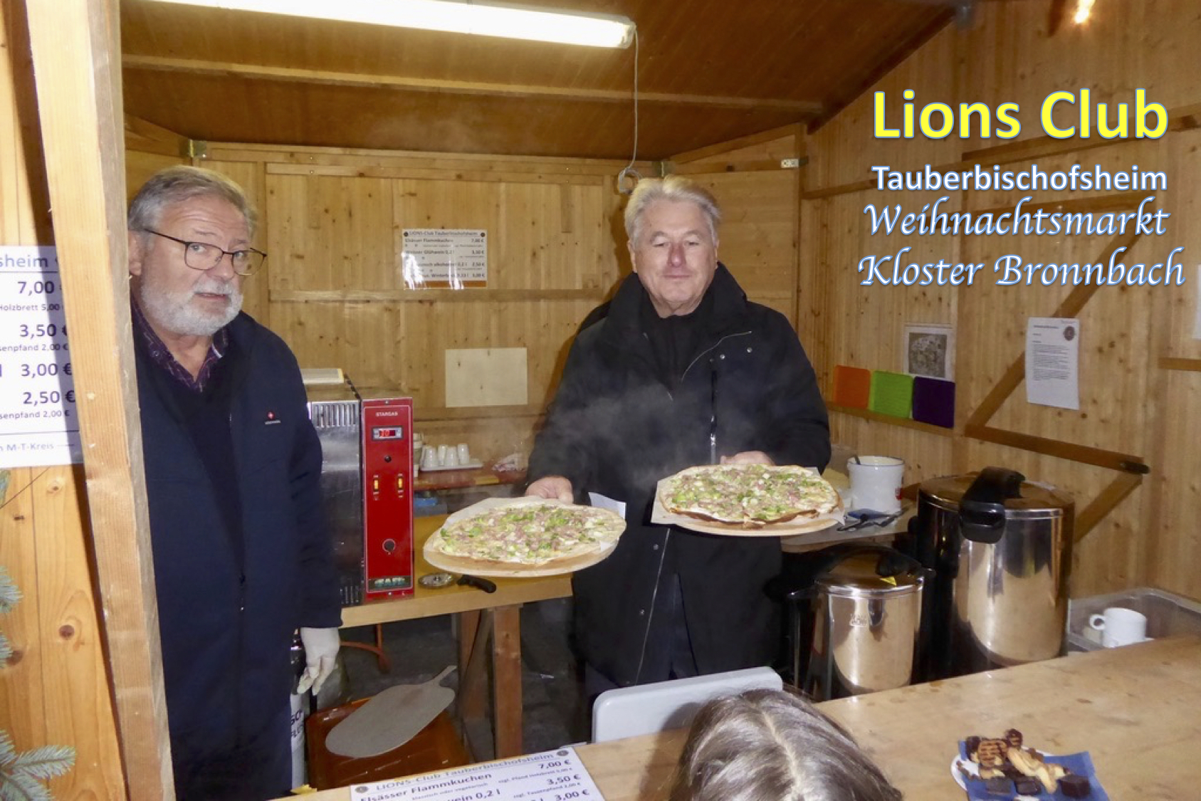 Georg Dobrowolsky (li) und Oskar Fuchs (re) bei der Ausgabe von Flammkuchen beim Weihnachtsmarkt am Kloster Bronnbach